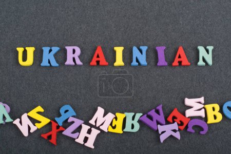 Photo for UKRAINIAN word on black board background composed from colorful abc alphabet block wooden letters, copy space for ad text. Learning english concept - Royalty Free Image