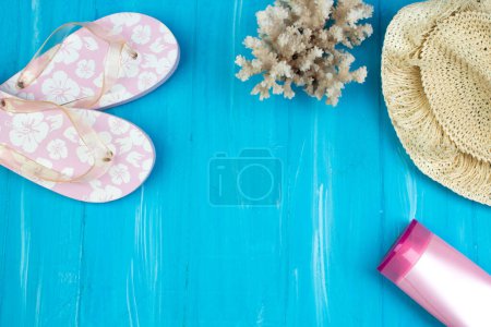 Photo for Straw hat,sunglasses and beach slippers on wood. Top view and copy space - Royalty Free Image
