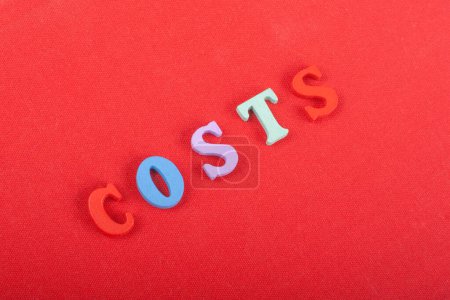 Photo for Costs word on red background composed from colorful abc alphabet block wooden letters, copy space for ad text. Learning english concept - Royalty Free Image