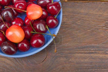 Photo for Various summer Fresh Cherry in a bowl on rustic wooden table. Antioxidants, detox diet, organic fruits. - Royalty Free Image