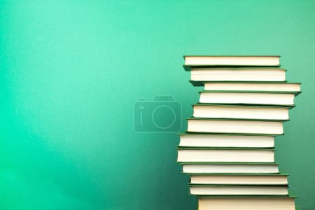 Photo for Books on wooden table, on a green background. Back to school. Copy space for text. Education background - Royalty Free Image