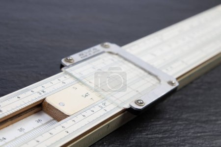 Photo for Logarithmic ruler on black background. Stationery for engineers and students - Royalty Free Image