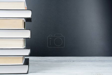 Photo for Open book, hardback black, White books on wooden table. Back to school. Copy space for text. Education business concept - Royalty Free Image
