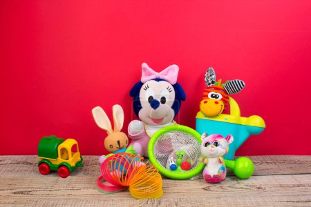 Foto de Colección de juguetes de colores sobre fondo rojo. Juguetes infantiles. - Imagen libre de derechos
