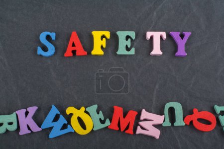 Photo for SAFETY word on black board background composed from colorful abc alphabet block wooden letters, copy space for ad text. Learning english concept - Royalty Free Image