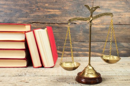 Photo for Law concept - Open law book, Judge's gavel, scales, Themis statue on table in a courtroom or law enforcement office. wooden background. - Royalty Free Image