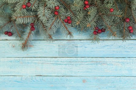 Photo for Christmas composition of fir branches and berries of viburnum on a wooden background - Royalty Free Image