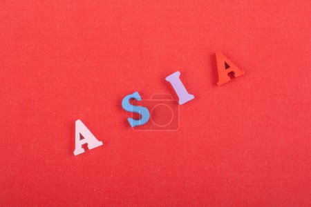 Photo for ASIA word on red background composed from colorful abc alphabet block wooden letters, copy space for ad text. Learning english concept - Royalty Free Image