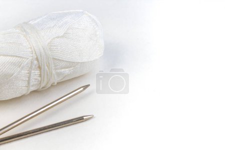 Photo for Pair of knitting needles isolated over white. Sweater or scarf White Crocheted Fabric Texture. Knitted jersey background with a relief pattern. Wool hand- machine, handmade - Royalty Free Image