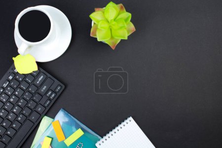 Photo for Black office table with computer, pen and a cup of coffee, lot of things. Top view with copy space - Royalty Free Image