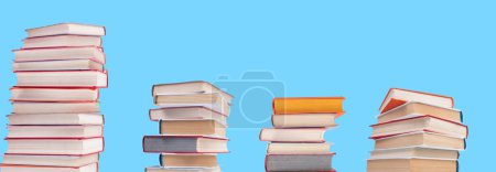Photo for Composition with hardback books on wooden deck table and blue background. Books stacking. Back to school. Copy Space. Education background - Royalty Free Image