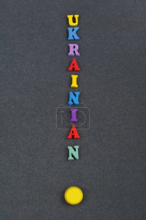 Photo for UKRAINIAN word on black board background composed from colorful abc alphabet block wooden letters, copy space for ad text. Learning english concept - Royalty Free Image