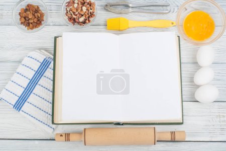 Photo for Recipe cook blank book on wooden background, spoon, rolling pin, checkered tablecloth. - Royalty Free Image