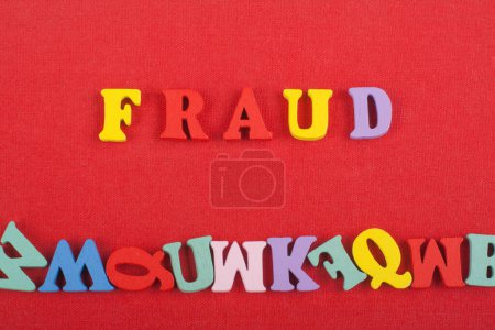 Photo for FRAUD word on red background composed from colorful abc alphabet block wooden letters, copy space for ad text. Learning english concept - Royalty Free Image