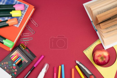 Photo for Back to school. Stationery on a Burgundy table. Office desk with copy space. Flat lay - Royalty Free Image