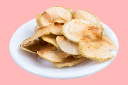 Photo for Sliced, dried apples in a plate isolated on pink background. Homemade organic apple - Royalty Free Image