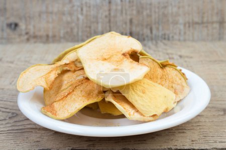 Photo for Homemade dried organic apple sliced on wood background - Royalty Free Image
