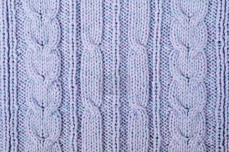 Photo for Sweater or scarf fabric texture large knitting. Knitted jersey background with a relief pattern. Braids in knitting . Wool hand- machine, handmade. - Royalty Free Image