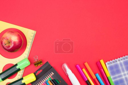 Photo for Back to school. Stationery on a red table. Office desk with copy space. Flat lay - Royalty Free Image