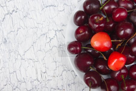 Photo for Various summer Fresh Cherry in a bowl on rustic wooden table. Antioxidants, detox diet, organic fruits. - Royalty Free Image