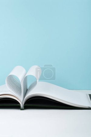 Photo for Old open hardback book, page decorate into a heart shape for love in Valentine's. love with open book heart - Royalty Free Image