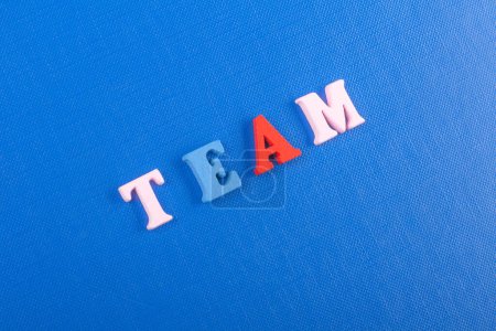 Photo for TEAM word on blue background composed from colorful abc alphabet block wooden letters, copy space for ad text. Learning english concept - Royalty Free Image