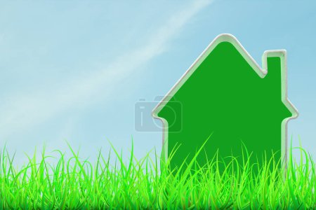 Téléchargez les photos : Modèle de maison verte en herbe verte sur fond de ciel bleu. Concept de maison verte - en image libre de droit
