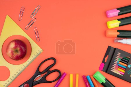 Photo for Back to school. Stationery on a salmon-orange color. color table. Office desk with copy space. Flat lay - Royalty Free Image