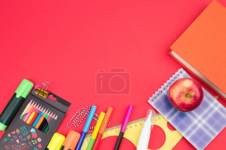 Photo for Back to school. Stationery on a red table. Office desk with copy space. Flat lay - Royalty Free Image
