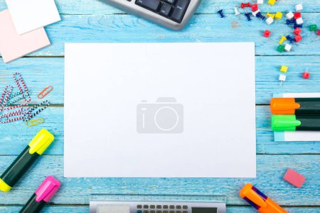Photo for Blue office desk table with computer, pen and a cup of coffee, lot of things. Top view with copy space - Royalty Free Image