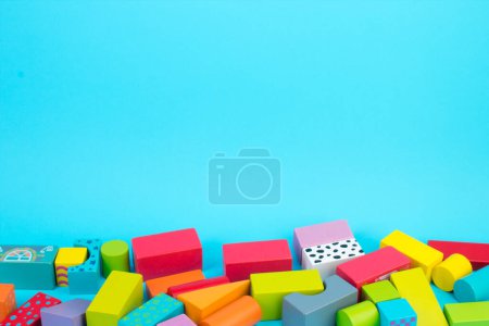 Photo for Top view of colorful wooden bricks on the table. Early learning. Educational toys on a blue background. For the development of the child. - Royalty Free Image