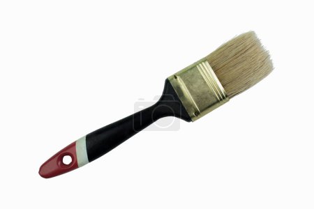 Photo for Flat paint brush with a rubberized black, red and white handle Isolated on white background. Copy space - Royalty Free Image