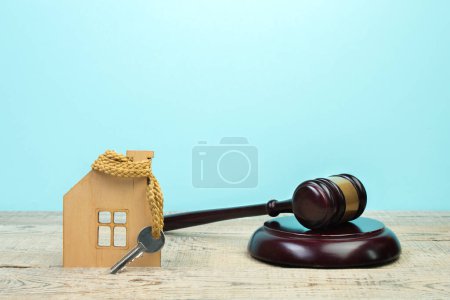 Photo for Law concept - Open law book with a wooden judges gavel on table in a courtroom or law enforcement office on blue background. Copy space for text - Royalty Free Image