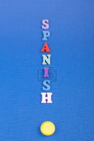 Photo for SPANISH word on black board background composed from colorful abc alphabet block wooden letters, copy space for ad text. Learning english concept - Royalty Free Image
