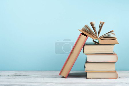 Photo for Open book, hardback colorful books on wooden table. Back to school. Copy space for text. Education business concept - Royalty Free Image