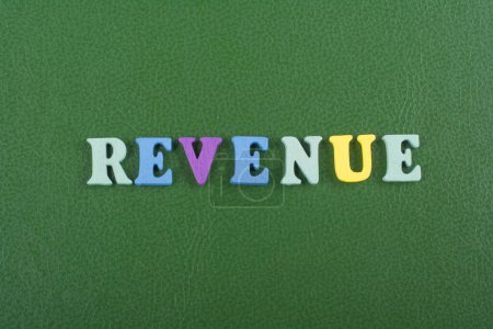 Photo for REVENUE word on green background composed from colorful abc alphabet block wooden letters, copy space for ad text. Learning english concept - Royalty Free Image