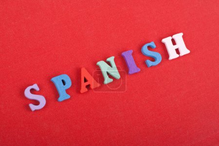 Photo for SPANISH word on red background composed from colorful abc alphabet block wooden letters, copy space for ad text. Learning english concept - Royalty Free Image