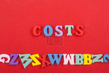 Photo for Costs word on red background composed from colorful abc alphabet block wooden letters, copy space for ad text. Learning english concept - Royalty Free Image