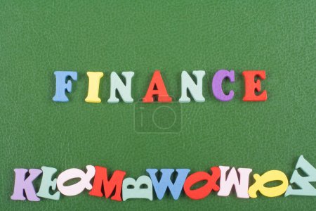 Photo for FINANCE word on green background composed from colorful abc alphabet block wooden letters, copy space for ad text. Learning english concept - Royalty Free Image