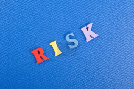 Photo for RISK word on blue background composed from colorful abc alphabet block wooden letters, copy space for ad text. Learning english concept - Royalty Free Image