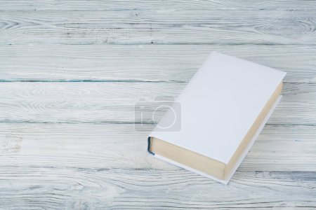 Photo for Book on a white wooden table. Education business concept - Royalty Free Image