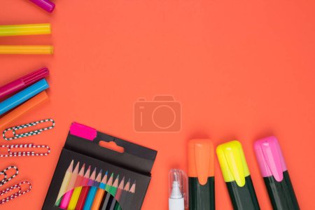 Photo for Back to school. Stationery on a salmon-orange color. color table. Office desk with copy space. Flat lay - Royalty Free Image