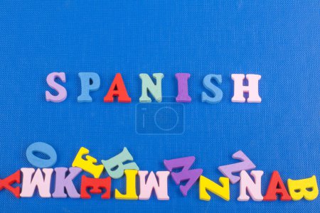 Photo for SPANISH word on blue background composed from colorful abc alphabet block wooden letters, copy space for ad text. Learning english concept - Royalty Free Image