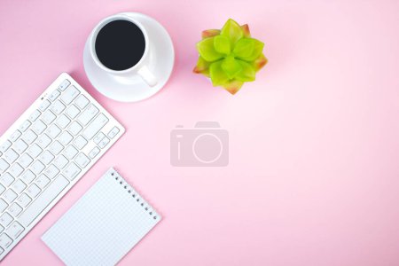 Photo for Pink office table with computer, pen and a cup of coffee, lot of things. Top view with copy space - Royalty Free Image