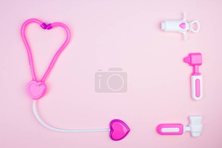 Photo for Children's medical instruments. The concept of a pediatrician. Pediatrics. Toy medical devices on a pink background. Choice of profession. Get vaccinated - Royalty Free Image