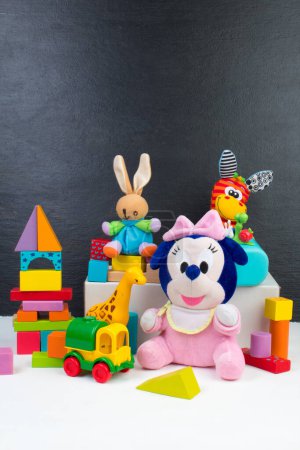 Photo for Collection of colorful toys on the background of the blackboard - Royalty Free Image