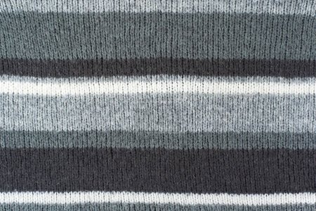 Pull ou écharpe tissu texture grand tricot. Fond en jersey tricoté avec un motif en relief. Laine à la main machine, fait à la main