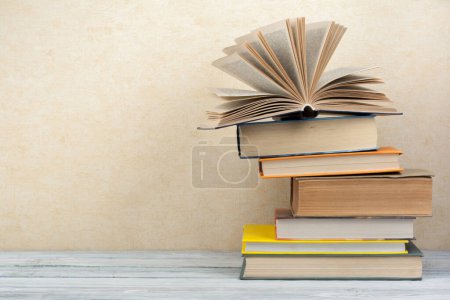 Photo for Stack of colorful books. Education background. Back to school. Book, hardback colorful books on wooden table. Education business concept. Copy space for text - Royalty Free Image