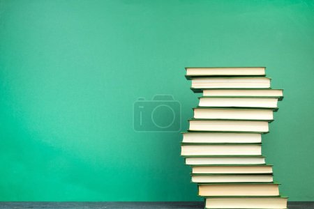 Photo for Books on wooden table, on a green background. Back to school. Copy space for text. Education background - Royalty Free Image