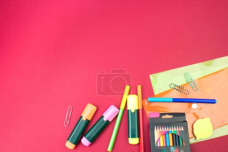 Photo for Back to school. Stationery on a Burgundy table. Office desk with copy space. Flat lay - Royalty Free Image